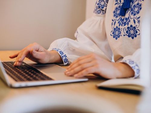 Free Photo | Young ukrainian woman wearing vyshyvanka working from home