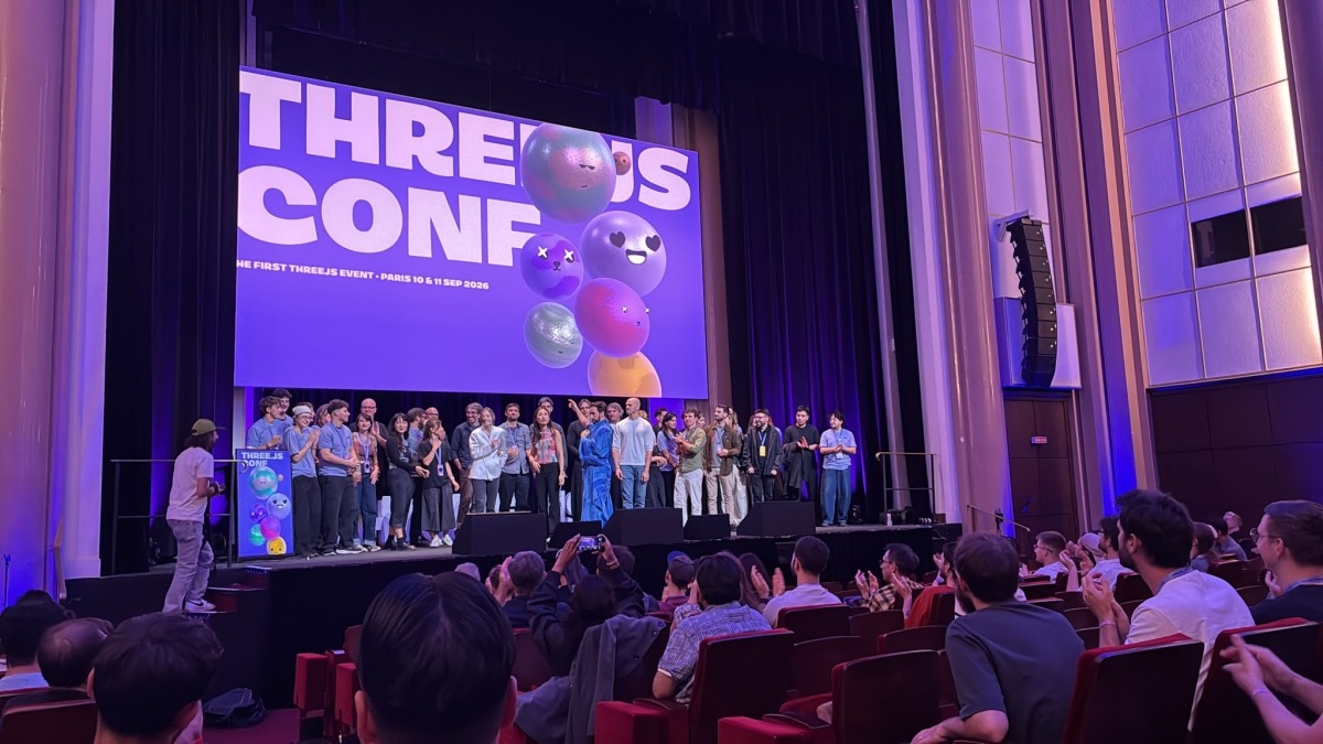 Speakers and organisers on stage under the Three.js Conf logo at the close of the event